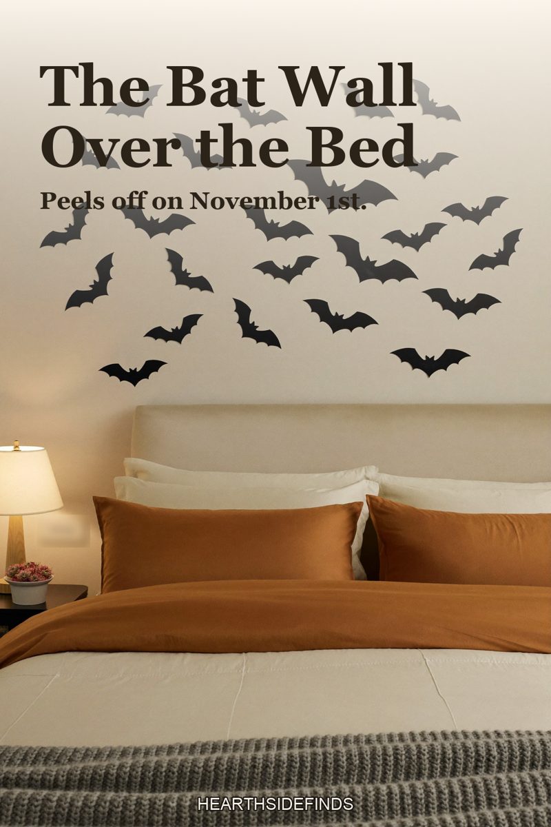 Bedroom with cream headboard and rust bedding, black paper bats flying across the wall above the bed.
