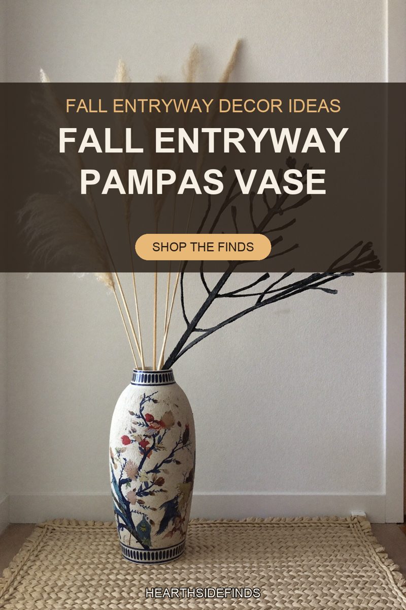Cream pampas plumes and a black painted branch in a floral ceramic floor vase on a woven jute mat.