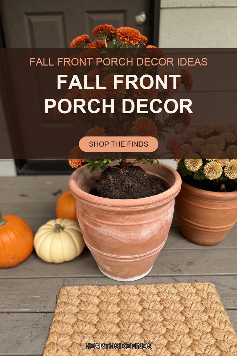 A rounded terracotta planter stands on weathered grey porch boards holding a rust-orange mum whose bare soil root ball mounds up above the pot's rim and whose upper blooms run behind the text panel. A second terracotta pot of cream and gold mums sits to its right, a large orange pumpkin cut off by the left edge stands beside a small cream pumpkin and a smaller orange one, a plain braided jute doormat lies flat on the boards in front, and a dark panelled front door with a round metal lock fills the background beside pale grey clapboard siding.