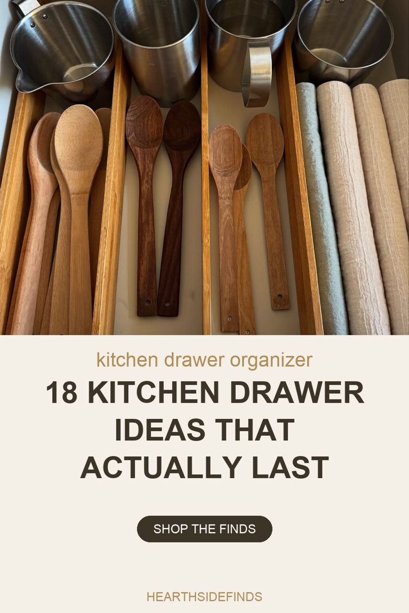 Photo looking down into an open kitchen drawer where bamboo dividers split the space into four lanes, each holding wooden spoons and flat spatulas sorted by shade, with four stainless steel pots resting across the top edge and folded linen towels standing on end in the right-hand lane